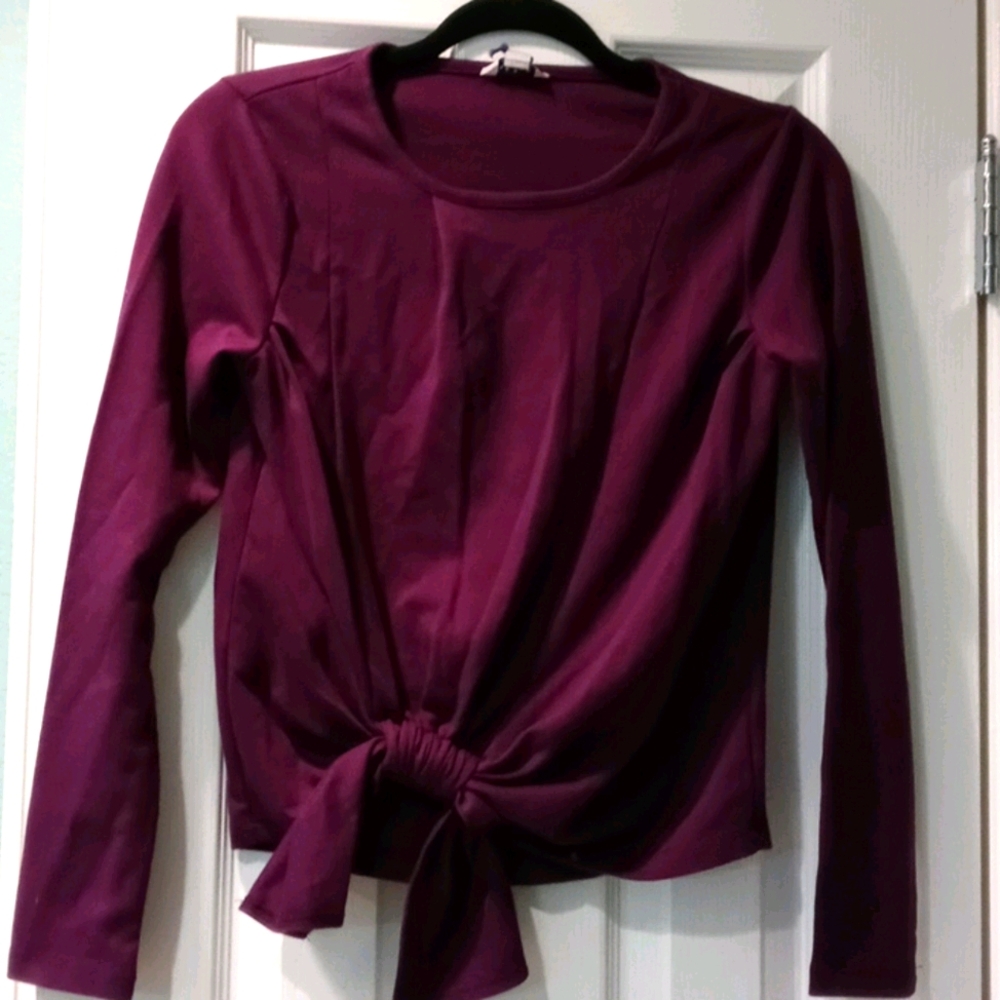 Plum colored long sleeve shirt tied at waist